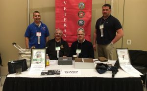 Raising funds for Disabled American Veterans: David Scholl of Upstate Medical University (Navy); Bill Borgstede of E.S.F. (Army); Justin Culkowski of E.S.F. (Air Force ); and William Meyer of Stony Brook HSC (Marines) staff the Veterans table at the Spring 2016 UUP Delegate Assembly.