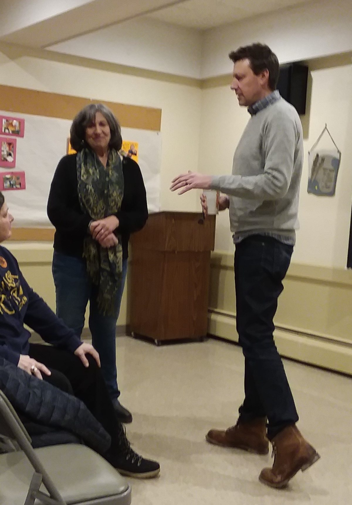 Virginia Kennedy and Josh Riley converse in recent meeting.