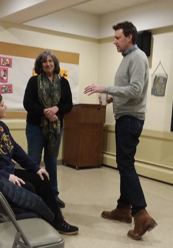 Virginia Kennedy and Josh Riley converse in recent meeting.