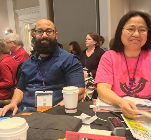 Two tired UUP Oneonta delegates smile for the camera.